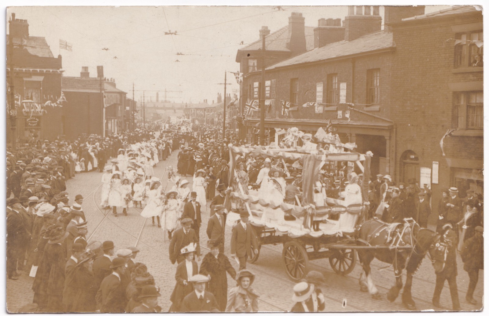 Postcard: Postcard, Unidentified Busy Procession Through Street. Real Photograph.: catalogue image 1